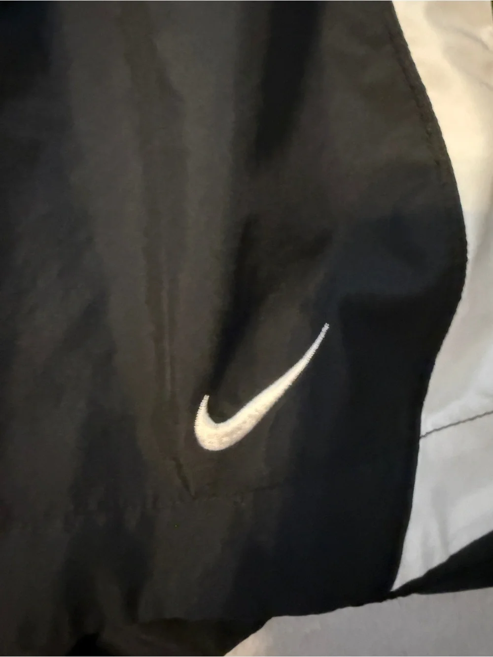 Nike Black Athletic Running Shorts with White Accents and Yellow Number